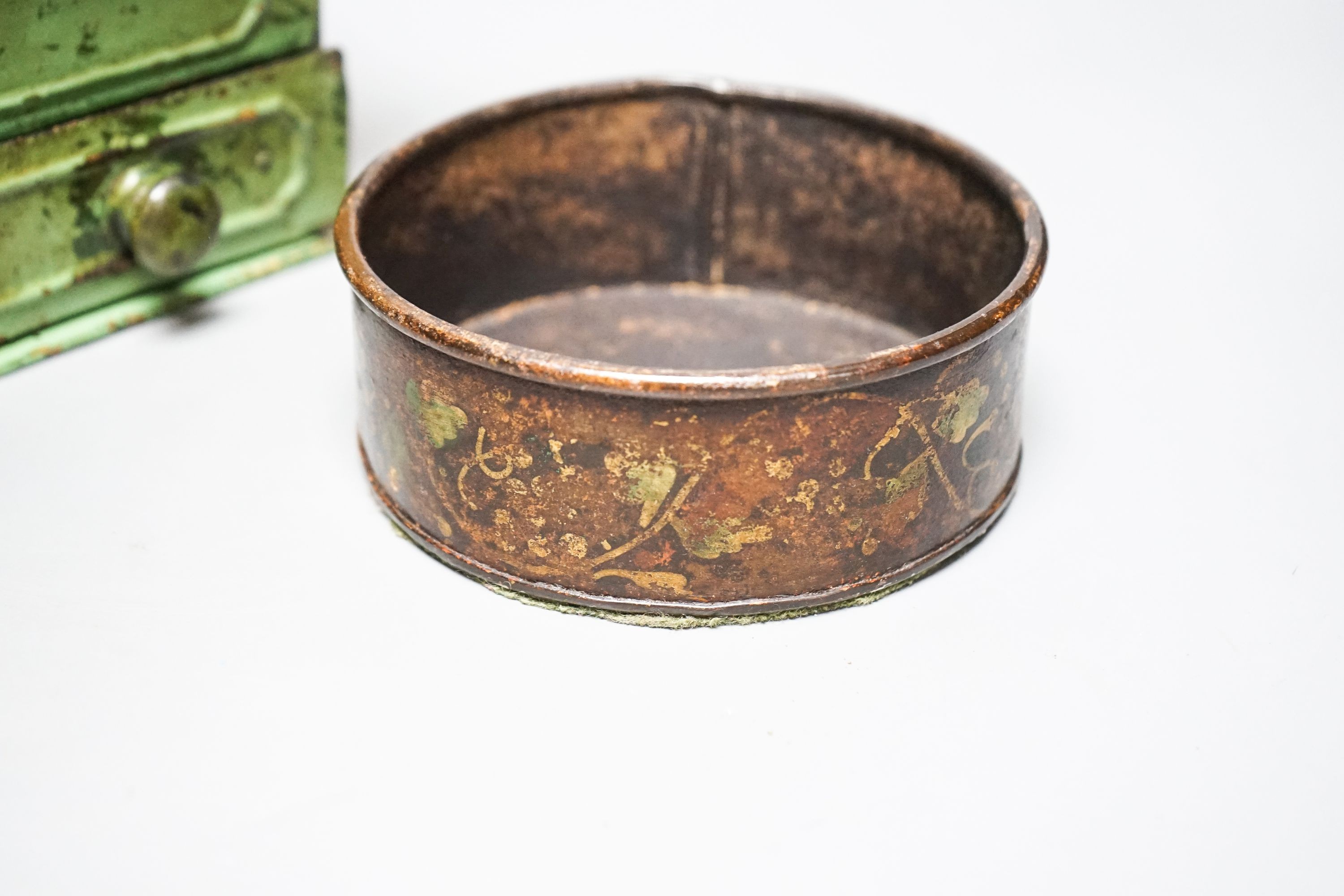 A pair of 19th century toleware coasters and a painted coffee grinder